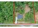 Aerial view of a wooded property featuring a modern home with a well-maintained lawn and long driveway at 8225 Long Island Rd, Catawba, NC 28609