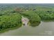 Scenic aerial view of wooded lot and a boat ramp with parking, bordering a beautiful lake at 8225 Long Island Rd, Catawba, NC 28609