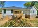 Exterior home view featuring the back of the house with a wooden deck, stairs, and partial brick foundation at 8225 Long Island Rd, Catawba, NC 28609