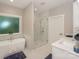 Luxurious bathroom featuring a soaking tub, glass-enclosed shower, and double vanity with modern fixtures at 8225 Long Island Rd, Catawba, NC 28609