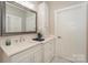 Bright bathroom features a modern vanity with white countertop, storage drawers, and a decorative mirror at 8225 Long Island Rd, Catawba, NC 28609