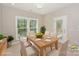 Bright dining room with a wood table set for six, large windows, and backyard views at 8225 Long Island Rd, Catawba, NC 28609