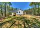Back of home features a well-maintained lawn and landscaping, offering a private outdoor retreat at 8225 Long Island Rd, Catawba, NC 28609