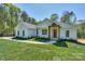 Inviting single-story home featuring a well-maintained lawn and stylish wooden accents on the front porch at 8225 Long Island Rd, Catawba, NC 28609