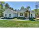 Charming single-story home featuring a beautifully landscaped front yard and inviting entrance with natural wood accents at 8225 Long Island Rd, Catawba, NC 28609