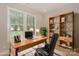 Bright home office featuring wood desk, large window, and built in bookcase at 8225 Long Island Rd, Catawba, NC 28609