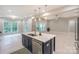 Open-concept kitchen with an island and stainless steel appliances, flowing into a spacious living area at 8225 Long Island Rd, Catawba, NC 28609