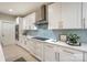 Bright kitchen featuring white cabinetry, subway tile backsplash, quartz countertops, and stainless steel range hood at 8225 Long Island Rd, Catawba, NC 28609