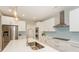Bright kitchen featuring stainless appliances, blue tile backsplash, and modern countertops at 8225 Long Island Rd, Catawba, NC 28609