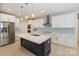 Modern kitchen featuring stainless steel refrigerator and a large island with a white countertop at 8225 Long Island Rd, Catawba, NC 28609