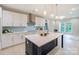 Modern kitchen with a large island, pendant lights, stainless steel appliances, and a light blue backsplash at 8225 Long Island Rd, Catawba, NC 28609