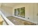 Covered outdoor patio showcases board and batten siding and three large windows overlooking the backyard at 8225 Long Island Rd, Catawba, NC 28609