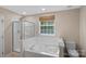 Bathroom with a tub, shower and a window with natural light at 831 Daly Cir, Fort Mill, SC 29715