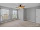 Bedroom featuring neutral walls, two bright windows, and a ceiling fan at 831 Daly Cir, Fort Mill, SC 29715