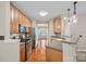 Well-equipped kitchen with stainless steel appliances and hardwood floors open to dining at 831 Daly Cir, Fort Mill, SC 29715