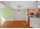 Open living room features hardwood floors, modern lighting, and adjacent kitchen with breakfast bar at 831 Daly Cir, Fort Mill, SC 29715