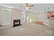Spacious open-concept living room featuring a fireplace, great natural light, and hardwood floors at 831 Daly Cir, Fort Mill, SC 29715