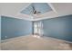 Main bedroom features a tray ceiling, ceiling fan, and neutral carpet at 831 Daly Cir, Fort Mill, SC 29715