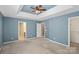 Spacious main bedroom with trey ceilings, ceiling fan, neutral carpet and entryways to closet and bathroom at 831 Daly Cir, Fort Mill, SC 29715