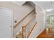 Carpeted staircase with white risers and wood railing in a neutral-toned hallway at 831 Daly Cir, Fort Mill, SC 29715