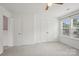 Well-lit bedroom featuring a double-door closet, a ceiling fan, and carpet at 9612 Eagle Feathers Dr, Charlotte, NC 28214