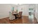 Formal dining room features modern light fixture, wainscoting, and a large wooden table with seating for six at 9612 Eagle Feathers Dr, Charlotte, NC 28214