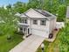 Two story home features solar panels, attached garage, light siding, and a well manicured lawn at 9612 Eagle Feathers Dr, Charlotte, NC 28214