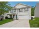 Well-maintained home features light siding, attached two-car garage, and a beautifully landscaped front yard at 9612 Eagle Feathers Dr, Charlotte, NC 28214