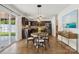 Eat-in kitchen features dark wood cabinets, stainless steel appliances, and a round dining table at 9612 Eagle Feathers Dr, Charlotte, NC 28214