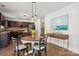 Eat-in kitchen features dark wood cabinets, stainless steel appliances, and stylish pendant lighting at 9612 Eagle Feathers Dr, Charlotte, NC 28214