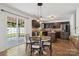 Eat-in kitchen features dark wood cabinets, stainless steel appliances, and sliding glass door to backyard at 9612 Eagle Feathers Dr, Charlotte, NC 28214