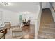 Spacious living room with wood floors, a staircase, and open concept design to the dining area at 9612 Eagle Feathers Dr, Charlotte, NC 28214