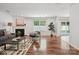 Bright living room featuring fireplace, hardwood floors, neutral tones, and sliding door to the backyard at 9612 Eagle Feathers Dr, Charlotte, NC 28214