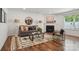 Inviting living room features a fireplace, stylish rug, comfortable seating, and a decorative round mirror at 9612 Eagle Feathers Dr, Charlotte, NC 28214