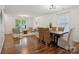Open living space features a dining table and chairs, additional seating, and hardwood flooring at 9612 Eagle Feathers Dr, Charlotte, NC 28214