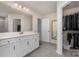 Bright bathroom featuring a double vanity, large mirror, and a walk-in closet at 1003 Dorsey Dr, Fort Mill, SC 29715