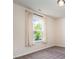 Empty bedroom with neutral walls and carpet and curtains letting in sunlight at 1003 Dorsey Dr, Fort Mill, SC 29715
