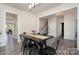 Dining room with black metal table and chairs, connecting to other rooms at 1003 Dorsey Dr, Fort Mill, SC 29715
