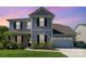 Charming two-story home with gray siding, black shutters, a two-car garage, and a manicured front lawn at 1003 Dorsey Dr, Fort Mill, SC 29715