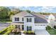 Stylish two-story home featuring a well-manicured lawn, two-car garage, and inviting front porch at 1003 Dorsey Dr, Fort Mill, SC 29715