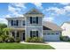 Two story home with a well-manicured lawn, landscaping, and a two-car garage at 1003 Dorsey Dr, Fort Mill, SC 29715