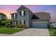 Home exterior with a well-manicured front lawn and a two-car garage at dusk at 1003 Dorsey Dr, Fort Mill, SC 29715