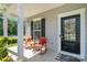 Inviting front porch featuring rocking chairs, stylish door, and elegant wreath decor at 1003 Dorsey Dr, Fort Mill, SC 29715
