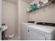 Functional laundry room featuring a washer, dryer, and shelving for storage at 1003 Dorsey Dr, Fort Mill, SC 29715
