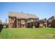 Expansive backyard featuring a covered patio and lush green lawn, perfect for outdoor living and entertaining at 10104 Silverling Dr, Waxhaw, NC 28173