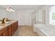 Spacious bathroom with double vanity, soaking tub, and separate glass-enclosed shower at 10104 Silverling Dr, Waxhaw, NC 28173