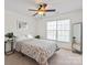 Bright bedroom with large window, ceiling fan, and neutral decor at 10104 Silverling Dr, Waxhaw, NC 28173