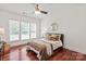 Comfortable bedroom with hardwood floors, natural light, and a ceiling fan at 10104 Silverling Dr, Waxhaw, NC 28173