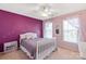 Charming bedroom with purple accent wall, white furniture, and natural light at 10104 Silverling Dr, Waxhaw, NC 28173