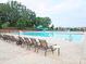 Large community pool with lounge chairs and a water slide, ideal for summer fun and relaxation at 10104 Silverling Dr, Waxhaw, NC 28173